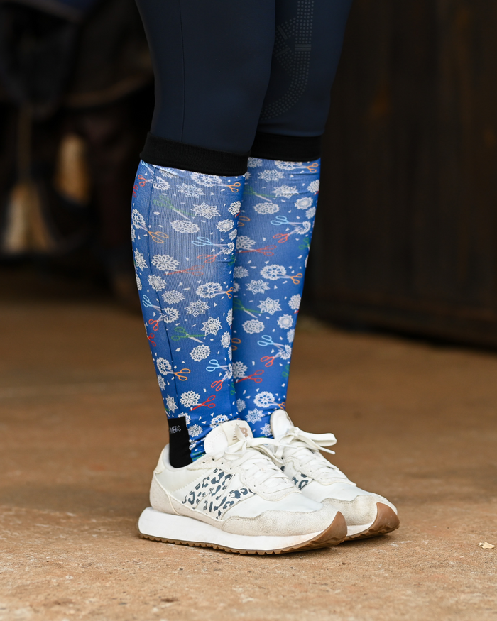 Shear Magic equestrian boot socks worn at the barn, cobalt blue with white clip rosettes and coloured scissors