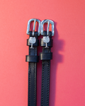 Black leather ManeJane spur straps with crystal-set silver wine glass charms on coral red
