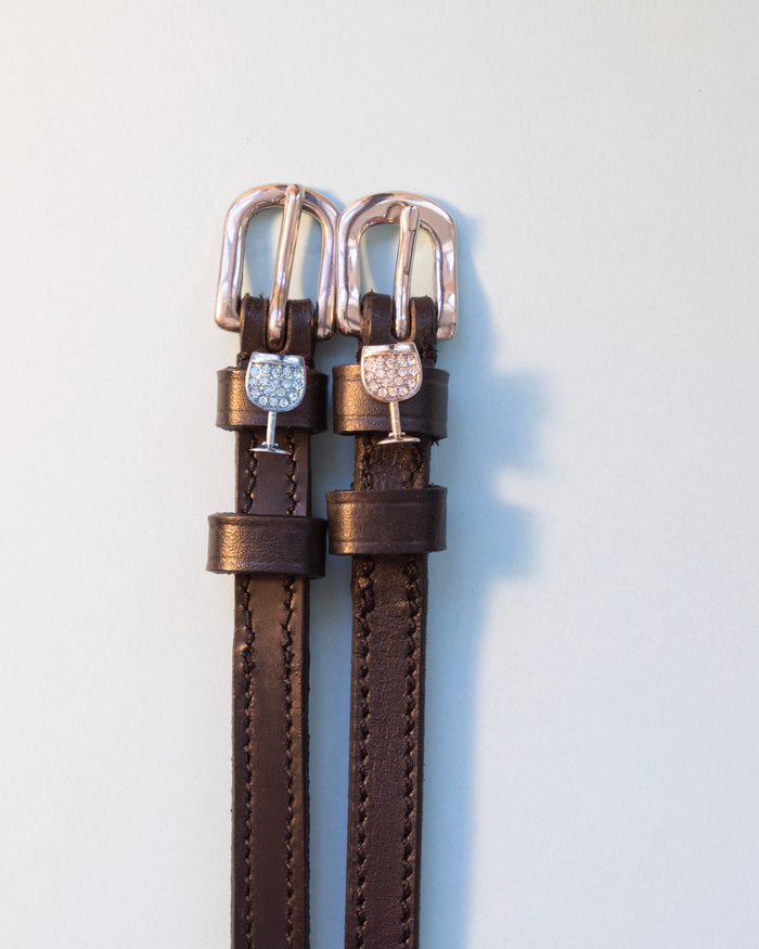 Brown leather crystal wine glass spur straps with rose gold buckles on pale grey