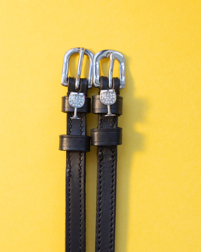 Black leather crystal wine glass ManeJane spur straps with silver buckles on yellow