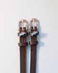 Brown leather ManeJane stingray spur straps with blue ray charms and rose-gold buckles