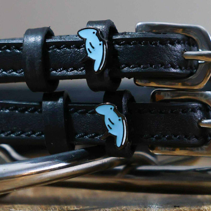 Close-up of blue enamel stingray charms on black leather ManeJane spur strap keepers