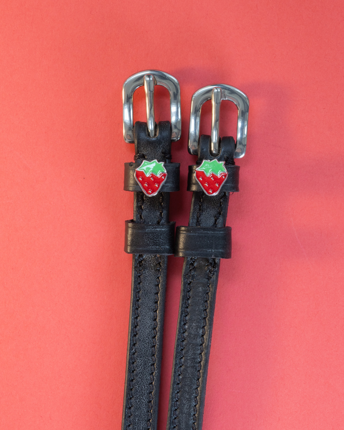 Black leather ManeJane strawberry spur straps with red enamel strawberry charms on coral