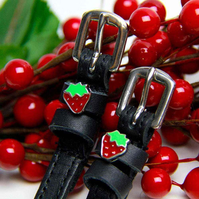 Strawberry spur straps with silver buckles among red berries and green leaves, ManeJane