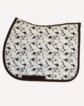 The Hunt saddle pad in cream printed with riding boots, helmets and bits, English pad shown flat by Dreamers & Schemers