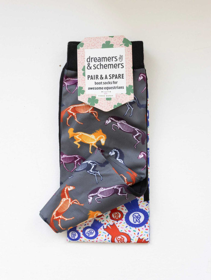 The Pony Island Horse Skeletons boot socks shown folded with the included spare sock and printed cuff detail