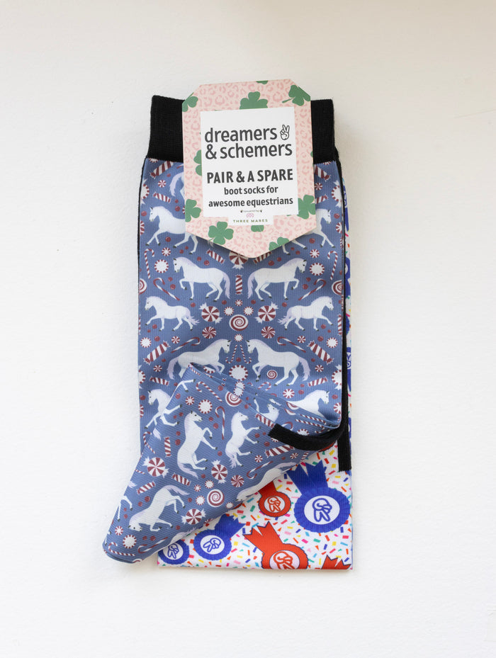 The Pony Island Peppermint Ponies youth boot socks shown folded with the included spare sock and patterned cuff