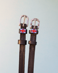 Brown leather ManeJane spur straps with enamel Union Jack flag charms on pale mint