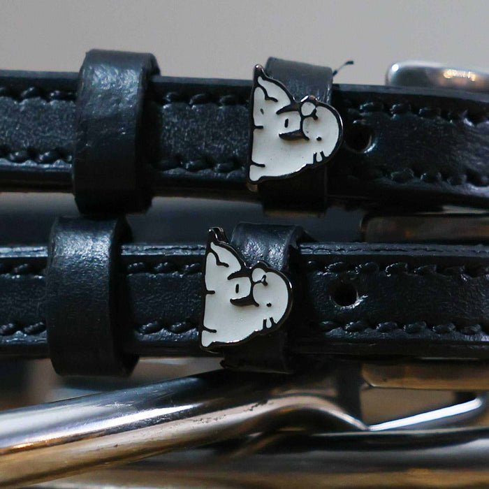 Black leather ManeJane spur straps with silver buckles and grey walrus charms on royal blue